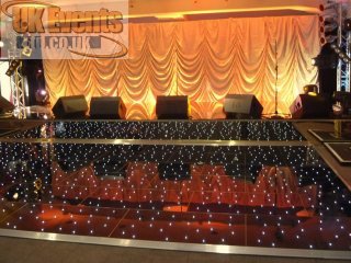 Black circular dance floor with rgb twinkling lights