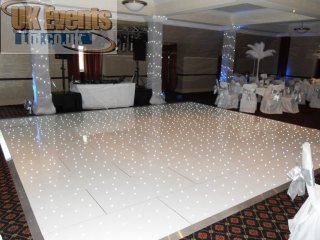 a white circular dance floor with rgb lights that twinkle